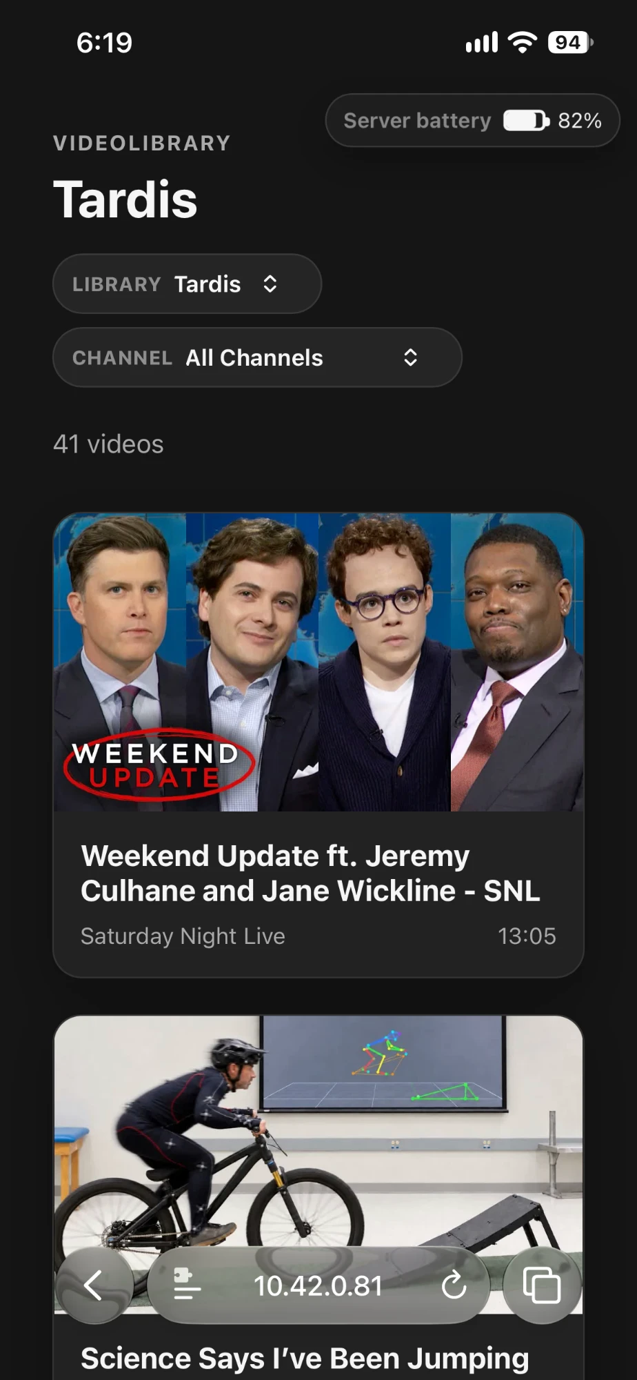 The shared library in a phone browser: library and channel pickers, the server's battery level, and video cards with titles, channels and lengths.
